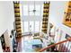 Bright and open living room with soaring ceilings, fireplace, and large windows with decorative drapes at 4850 Guilford Forest Sw Dr, Atlanta, GA 30331