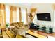 Inviting living room with cozy seating, large windows, and a modern entertainment center at 4850 Guilford Forest Sw Dr, Atlanta, GA 30331