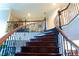 Elegant curved staircase with wrought iron railing adds architectural detail to the home's entryway at 4850 Guilford Forest Sw Dr, Atlanta, GA 30331