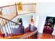 Beautiful staircase with custom ironwork and gorgeous wood treads offer a refined and welcoming ambiance at 4850 Guilford Forest Sw Dr, Atlanta, GA 30331