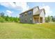 Spacious backyard with green lawn, partial fence, and covered porch, ideal for outdoor activities at 3201 Camden Ct, Atlanta, GA 30349