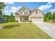 Charming two-story home featuring brick facade, well-manicured lawn, and an attached two-car garage at 3201 Camden Ct, Atlanta, GA 30349