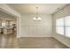 Dining room with wainscoting detail, an elegant chandelier, and natural light from the large windows at 3201 Camden Ct, Atlanta, GA 30349