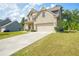Two-story home with brick and siding accents, attached two-car garage, and a long driveway at 3201 Camden Ct, Atlanta, GA 30349