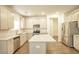 Well-equipped kitchen featuring white cabinets, stainless steel appliances, granite counters, and central island at 3201 Camden Ct, Atlanta, GA 30349