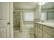 Bathroom featuring a glass enclosed shower, soaking tub, and double vanity at 3201 Camden Ct, Atlanta, GA 30349