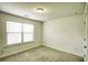 This is a simple bedroom with neutral carpet, a single window, and standard lighting at 3201 Camden Ct, Atlanta, GA 30349