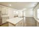 Beautiful kitchen featuring granite countertops, white cabinets, and a central island for added workspace at 3201 Camden Ct, Atlanta, GA 30349