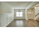 Formal dining room with hardwood floors, wainscoting, and a view of staircase to second level at 3201 Camden Ct, Atlanta, GA 30349