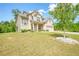 Well-maintained two-story home with a brick facade and lush green lawn and professional landscaping at 3201 Camden Ct, Atlanta, GA 30349