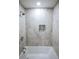 Bright white bathroom featuring updated tile floors and tub at 1466 Hardin Ave, Atlanta, GA 30337