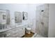 Bright bathroom featuring dual mirrors, marble countertop, and sleek shower with modern fixtures at 1466 Hardin Ave, Atlanta, GA 30337
