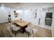 Open floor plan featuring a bright dining room with hardwood floors and a large wooden table at 1466 Hardin Ave, Atlanta, GA 30337