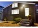 View of a house exterior with dark siding, multiple windows, and a small front porch at 1466 Hardin Ave, Atlanta, GA 30337