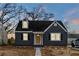 Charming home with gray siding, black shutters, a welcoming yellow front door, and landscape lighting at 1466 Hardin Ave, Atlanta, GA 30337