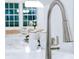 Close-up of a modern kitchen faucet with marble countertops, creating a clean and sophisticated look at 1466 Hardin Ave, Atlanta, GA 30337