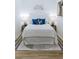 A cozy main bedroom offers a comfortable white bed with blue pillows and stylish bedside tables at 1466 Hardin Ave, Atlanta, GA 30337