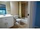 Cozy bathroom featuring a vanity, toilet, and shower with a decorative shower curtain at 403 Pebblebrooke Ln, Canton, GA 30115