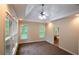 Bedroom with recessed lighting, fan, tray ceilings, and large windows with outdoor views at 403 Pebblebrooke Ln, Canton, GA 30115