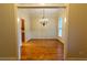 Formal dining room with hardwood flooring, crown molding, wainscoting, a chandelier and natural lighting at 403 Pebblebrooke Ln, Canton, GA 30115