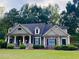 Charming single-Gathering home features beautiful landscaping, stone accents, and a welcoming porch at 403 Pebblebrooke Ln, Canton, GA 30115