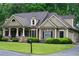 Charming home with well-manicured landscaping, a stone-accented facade, and inviting front porch at 403 Pebblebrooke Ln, Canton, GA 30115