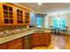 Cozy eat-in kitchen featuring granite countertops, wood cabinets, stainless steel appliances, and hardwood floors at 403 Pebblebrooke Ln, Canton, GA 30115