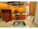 Modern kitchen with granite counters, stainless appliances, wooden cabinetry, and a sink overlooking the yard at 403 Pebblebrooke Ln, Canton, GA 30115
