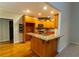 Bright kitchen featuring a breakfast bar, granite countertops, wood cabinets, and stainless steel appliances at 403 Pebblebrooke Ln, Canton, GA 30115