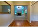 A view of the formal living room with a fireplace, hardwood floors, and many windows for natural light at 403 Pebblebrooke Ln, Canton, GA 30115