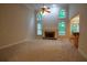 Open living room featuring a stone fireplace, large windows, and high ceilings with a ceiling fan at 403 Pebblebrooke Ln, Canton, GA 30115