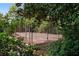 Community tennis court nestled among lush green trees at 102 Cedar Chase Rd, Atlanta, GA 30324