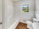 Clean bathroom features a white tub, tile surround, and bright window at 741 Prince Ave, Marietta, GA 30062