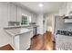 Updated kitchen featuring stainless steel appliances, granite countertops, and dark hardwood floors at 741 Prince Ave, Marietta, GA 30062