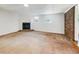 Bright living room featuring a cozy fireplace, a large carpet, and a brick wall at 741 Prince Ave, Marietta, GA 30062