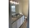 Bathroom with double vanity, granite countertop, and wood-look flooring at 6258 Crooked Creek Dr, Rex, GA 30273