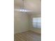 Dining room features a modern chandelier and large window, creating an elegant atmosphere at 6258 Crooked Creek Dr, Rex, GA 30273