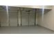 Two-car garage featuring a painted concrete floor and metal doors at 6258 Crooked Creek Dr, Rex, GA 30273