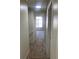 Carpeted hallway leading to a room with a window at 6258 Crooked Creek Dr, Rex, GA 30273
