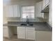 Bright kitchen features granite countertops, stainless steel appliances, and ample cabinet space at 6258 Crooked Creek Dr, Rex, GA 30273
