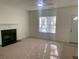 Cozy living room features a fireplace and large windows for ample natural light at 6258 Crooked Creek Dr, Rex, GA 30273