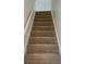 Carpeted staircase with white risers at 6258 Crooked Creek Dr, Rex, GA 30273