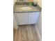 Bathroom vanity features granite countertop, white cabinets, and wood-look floors at 6258 Crooked Creek Dr, Rex, GA 30273