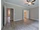 Bedroom with hardwood floors, a ceiling fan, and doorways leading to other areas of the house at 124 Sunflower Ne Cir, Cartersville, GA 30121