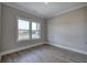 Neutral bedroom boasts sleek floors and a view of the outdoors from a large window at 124 Sunflower Ne Cir, Cartersville, GA 30121