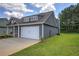A view of the house shows siding, roofline, and the two car garage at 124 Sunflower Ne Cir, Cartersville, GA 30121