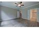 Bedroom with hardwood floors, a ceiling fan, and doorways leading to a bathroom and other rooms at 124 Sunflower Ne Cir, Cartersville, GA 30121