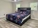 Primary bedroom with king-size bed and wood-look floors at 4132 Scenic Mountain Dr, Snellville, GA 30039