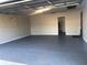 Spacious garage with painted floor and extra storage at 4132 Scenic Mountain Dr, Snellville, GA 30039