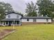 White house with black trim, large backyard, and sunroom at 4132 Scenic Mountain Dr, Snellville, GA 30039